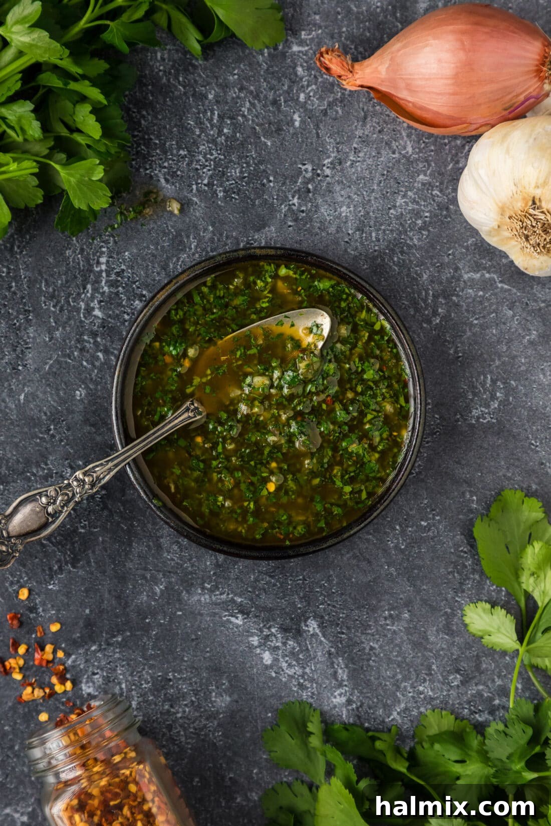 Fresh Chimichurri with Spoon Bowl of freshly made chimichurri sauce with a spoon resting in it.