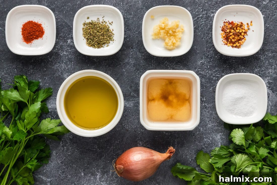 Chimichurri Ingredients Layout A collection of fresh ingredients laid out, ready for making chimichurri: parsley, cilantro, garlic, shallot, olive oil, vinegar, and spices.