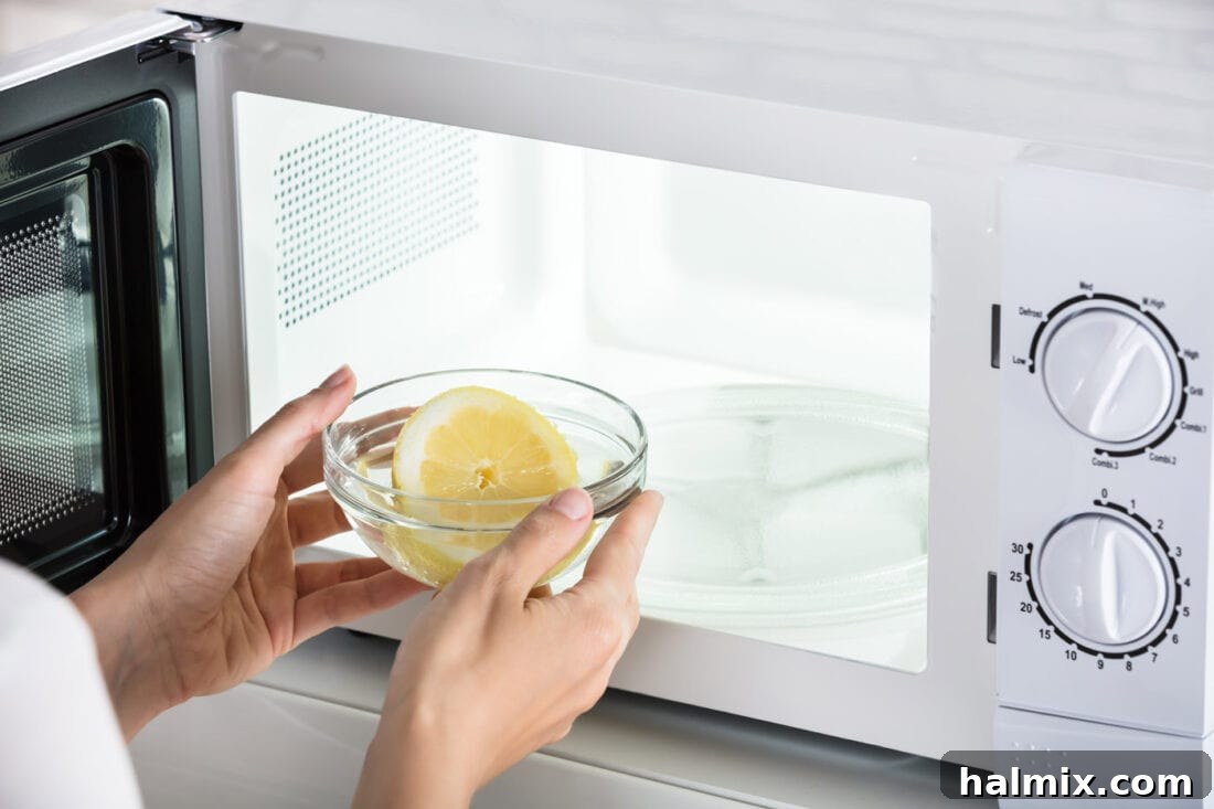 Hand wiping a clean microwave interior