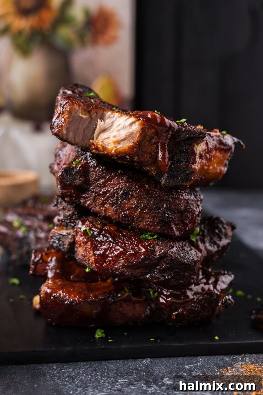A delectable stack of perfectly cooked Country Style Ribs, glistening with barbecue sauce and ready to be devoured.