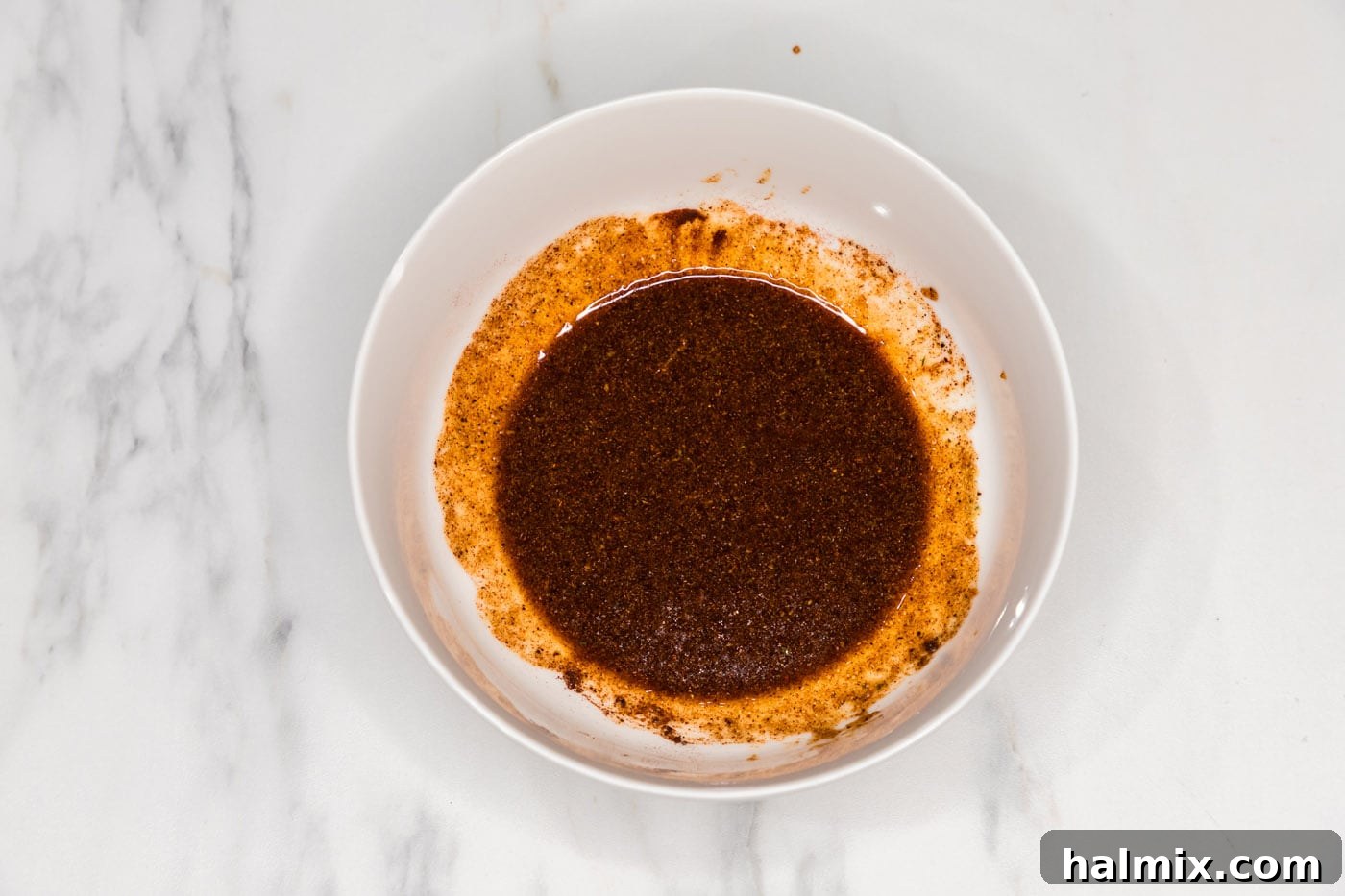 Preparing the flavorful wet rub ingredients in a bowl for the country style ribs.