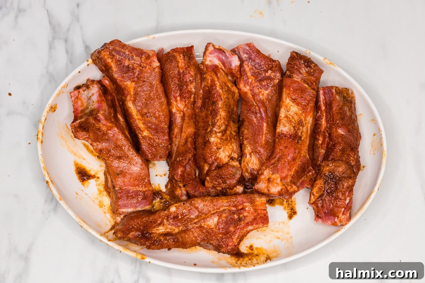 The country style ribs fully coated in the wet rub, ready for searing.