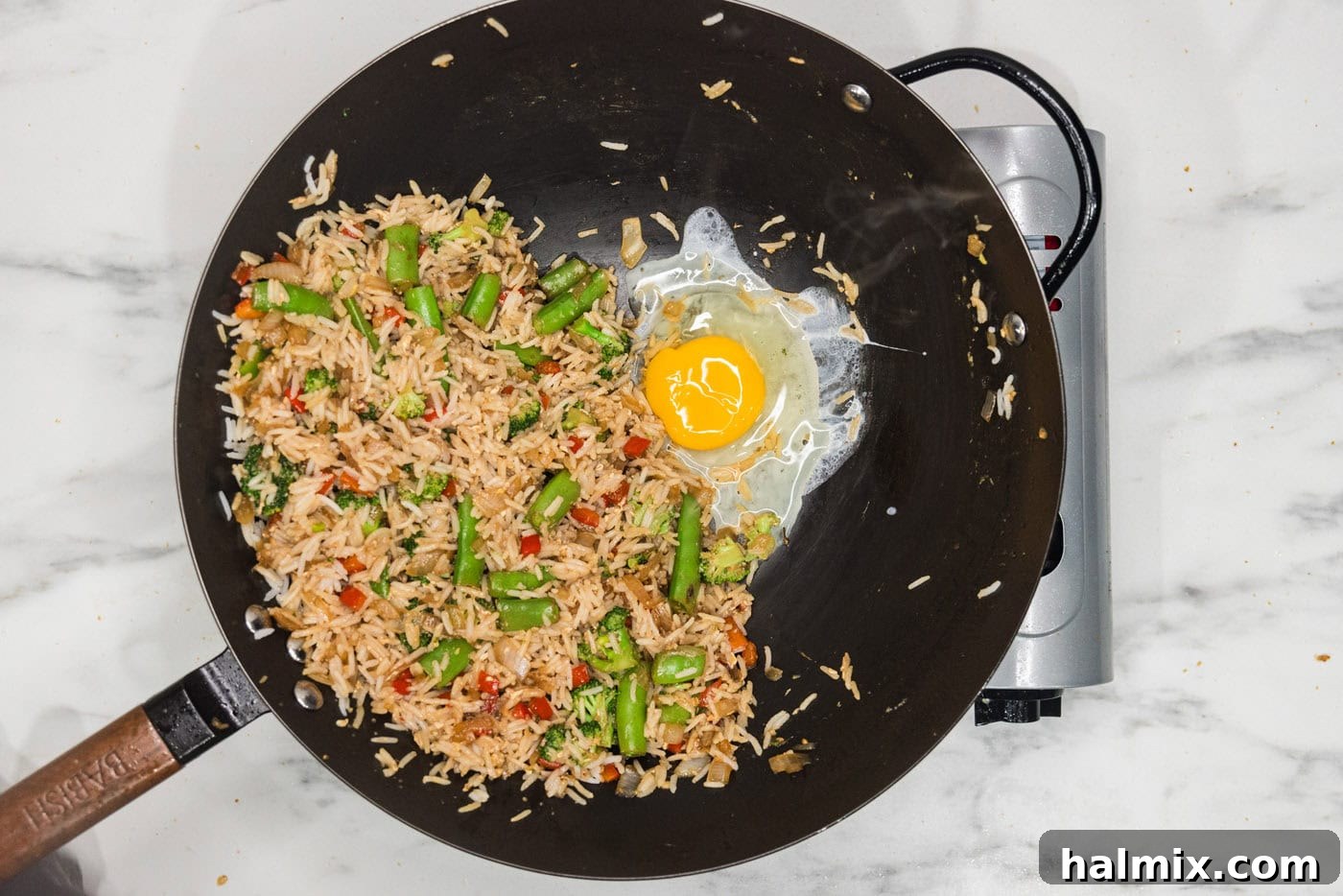 egg cooked in skillet with fried rice