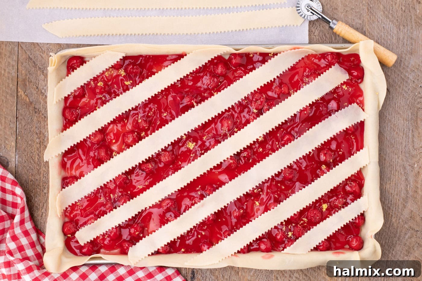 layering strips of pie crust over slab pie horizontally