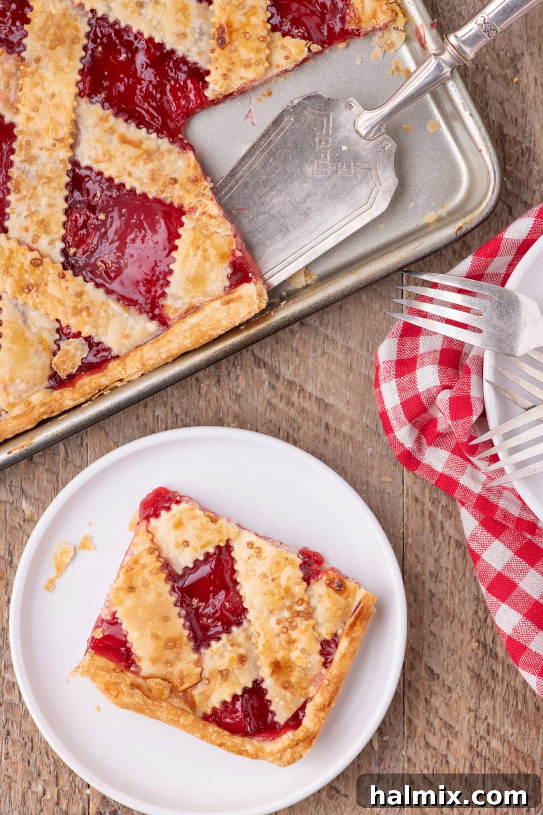 Slice of Cherry Slab Pie on a plate with the slab pie above it
