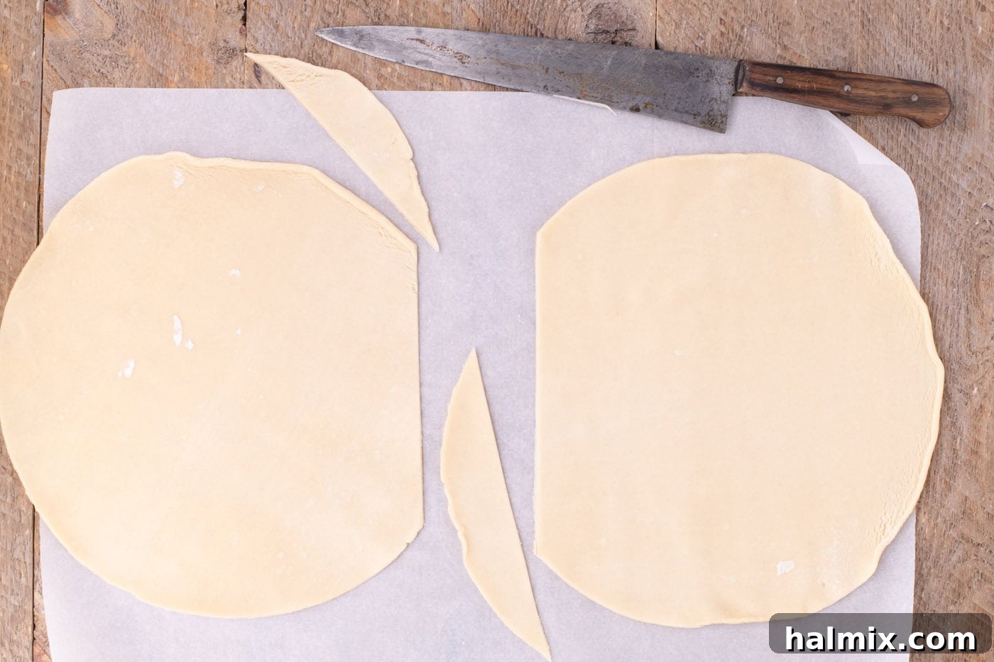 trimmed premade pie crust on parchment paper