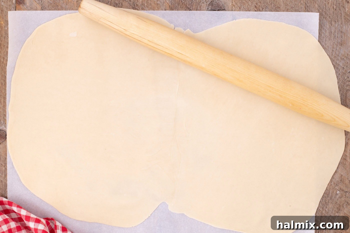rolling together premade pie crusts with a rolling pin