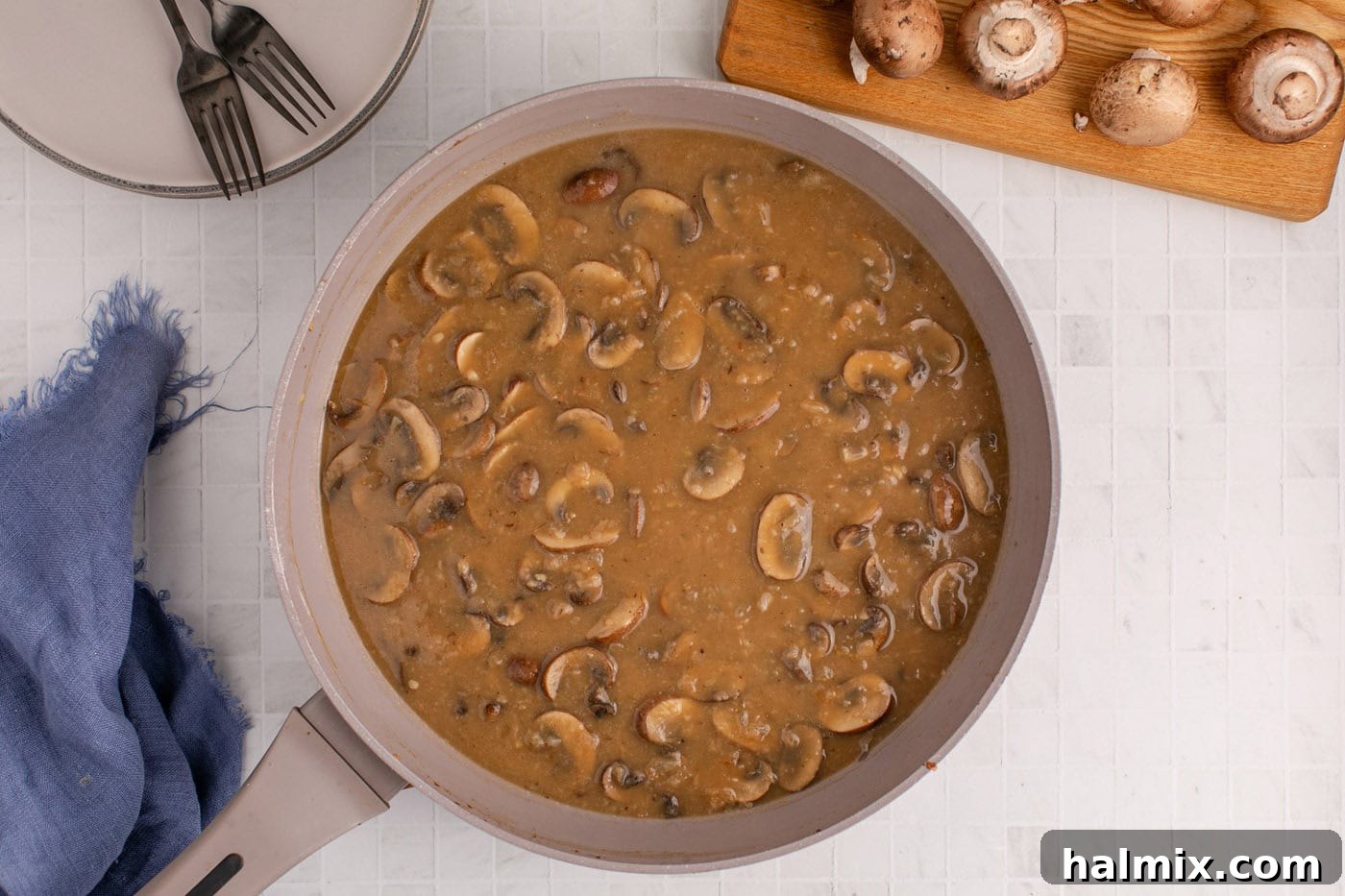 Rich, thickened Salisbury steak gravy simmering in a skillet