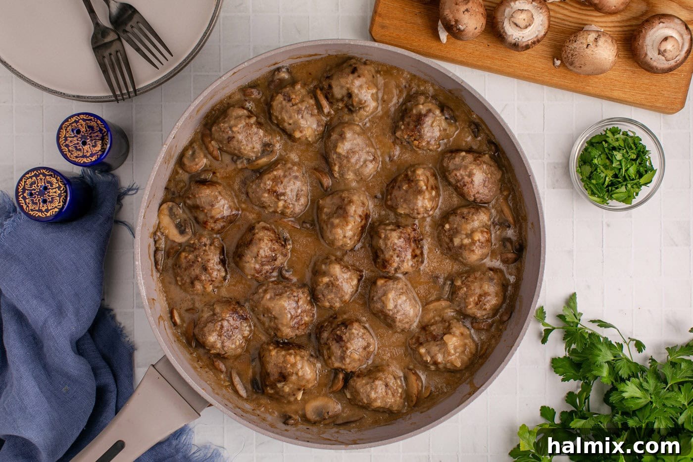 Finished overhead view of Salisbury Steak Meatballs coated in gravy in a skillet, ready to be served
