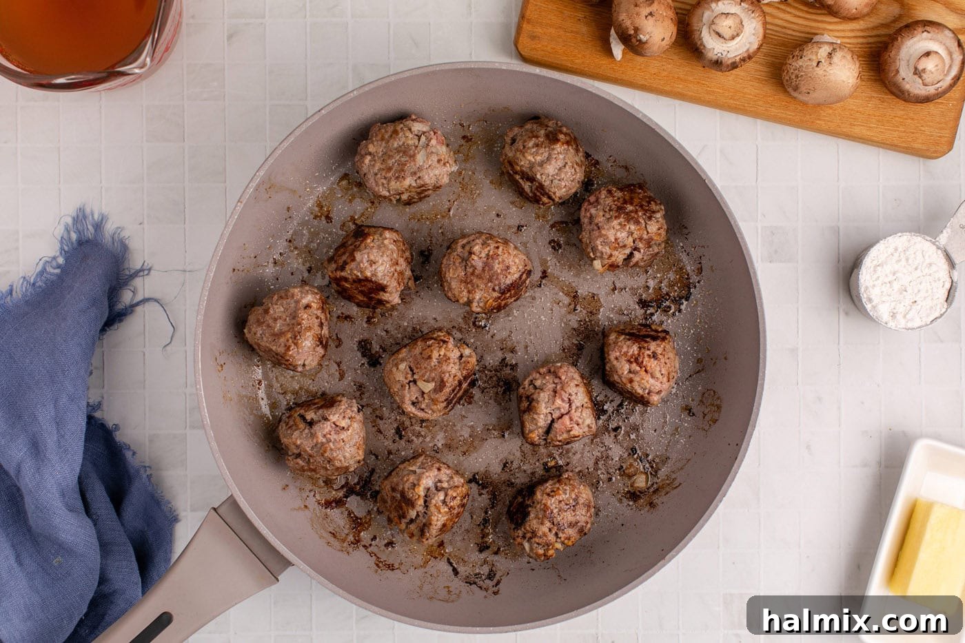 Cooking ground beef meatballs in a hot skillet until golden brown