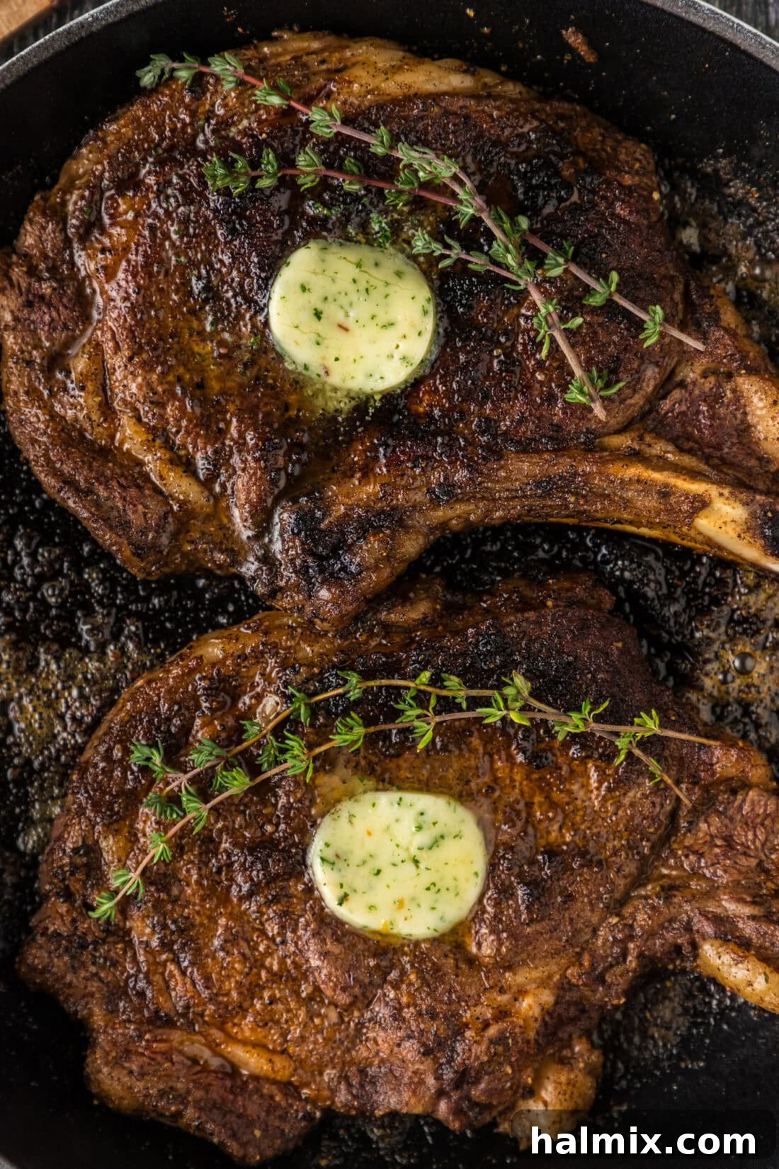 Close up photo of two Bone in Ribeyes in a skillet