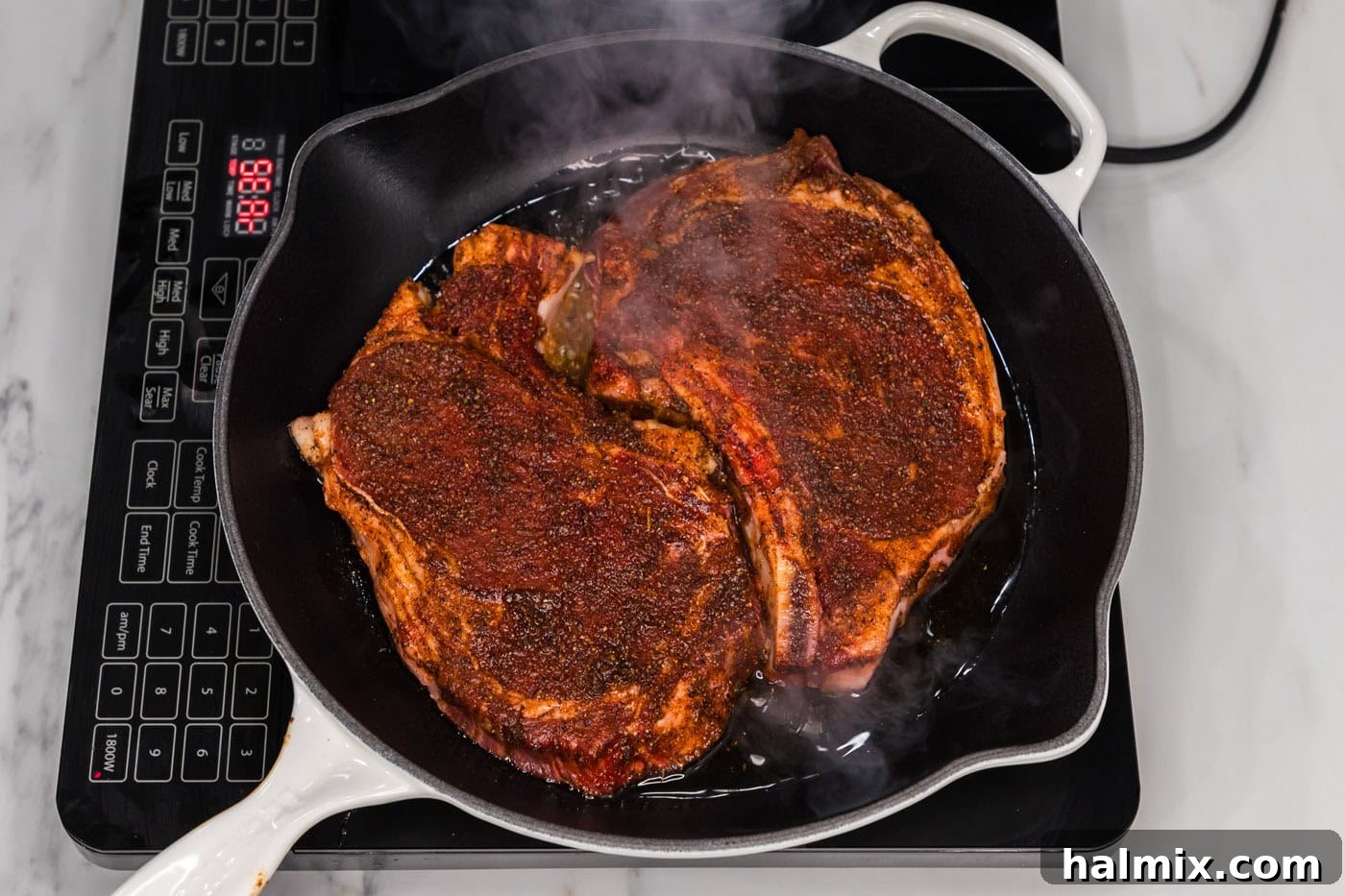searing ribeye steaks in a skillet