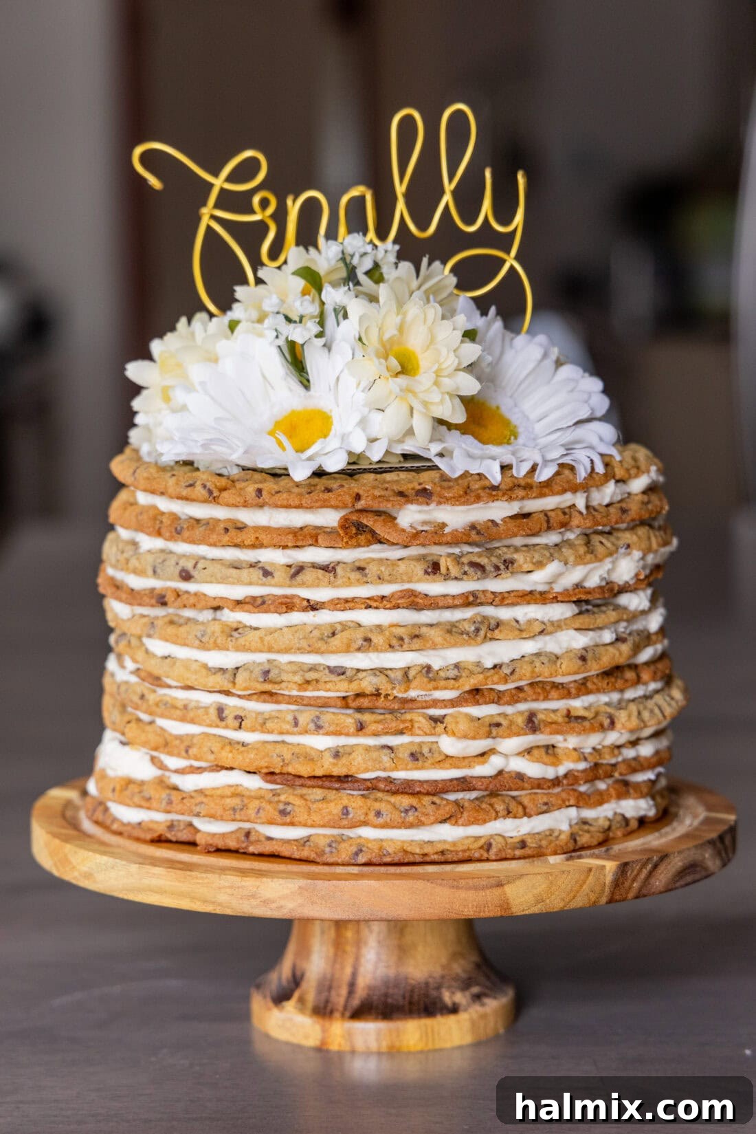 Photo of a Chocolate Chip Cookie Tower topped with flowers and a cake topper that says finally