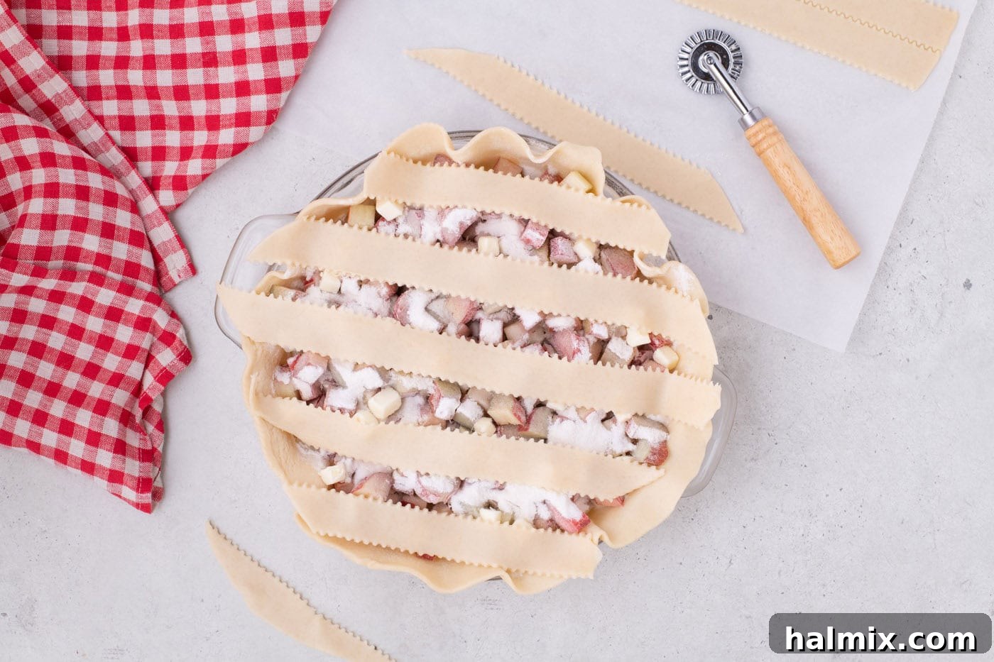 Tangy Rhubarb Delight 11 Five horizontal strips of pie crust laid evenly over the rhubarb filling in a pie pan.