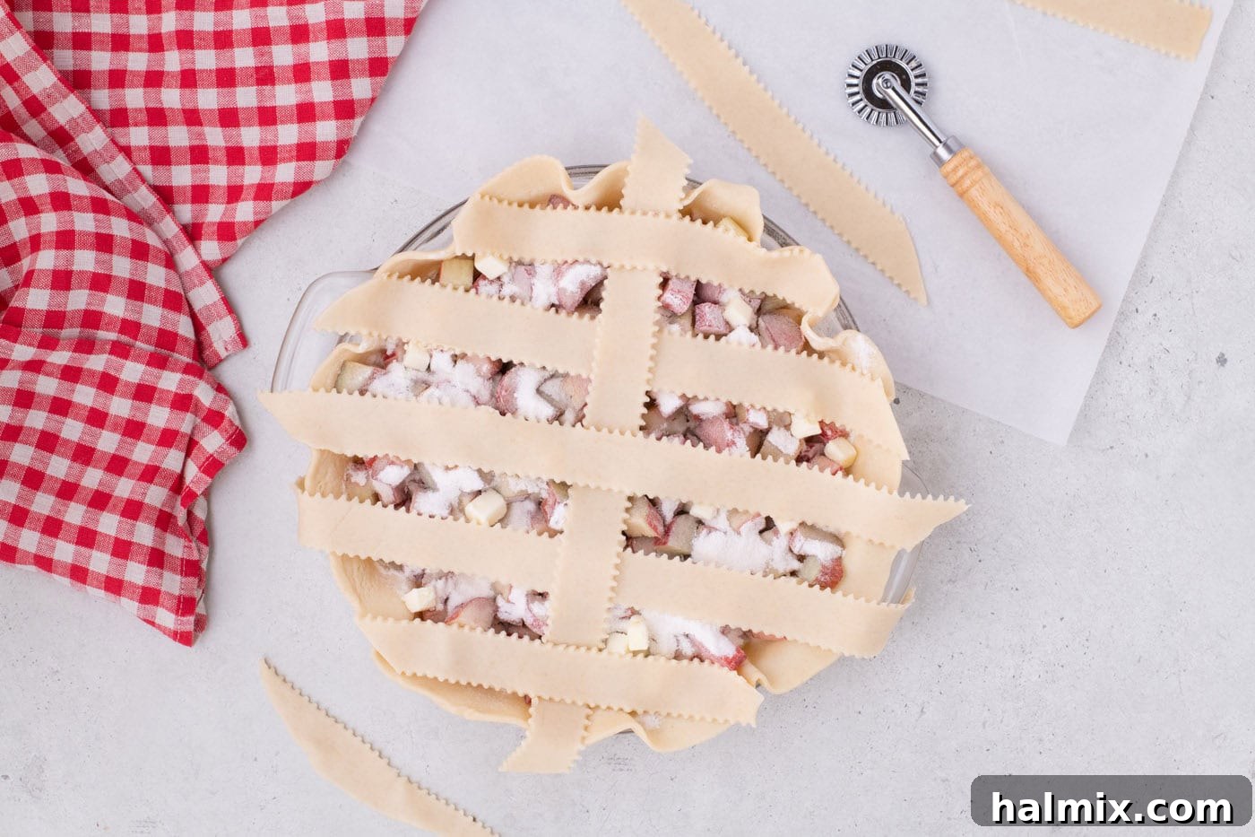 Tangy Rhubarb Delight 13 The first perpendicular strip woven into the lattice, with folded strips brought back over it.