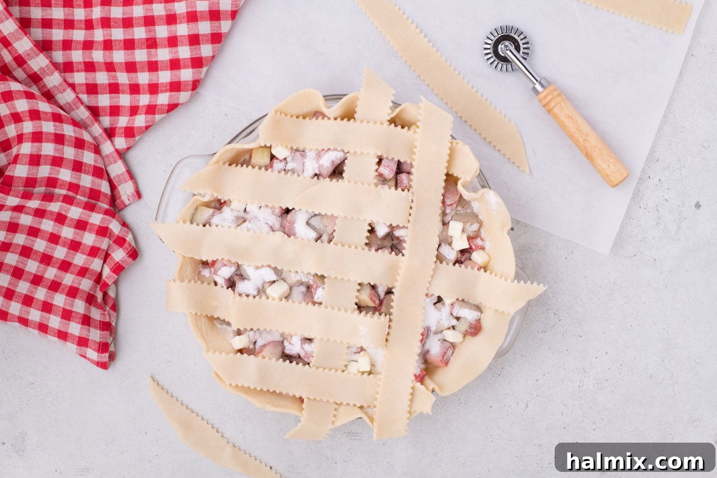 Tangy Rhubarb Delight 14 The next set of alternate pie crust strips folded back to continue the weaving process.