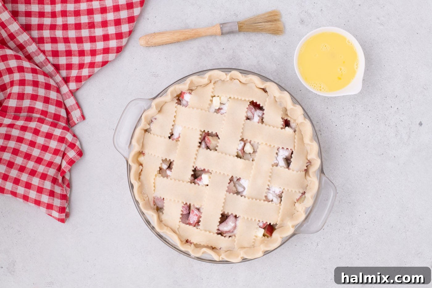 Tangy Rhubarb Delight 18 The lattice top pie crust brushed with a glistening egg wash, ready for the next step.