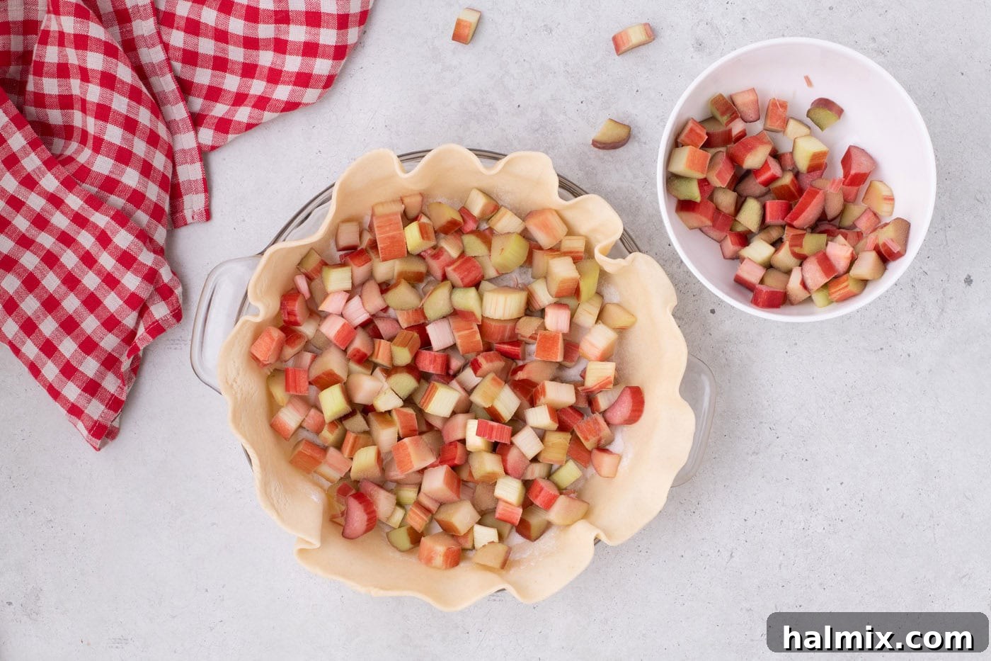Tangy Rhubarb Delight 8 Chopped rhubarb evenly distributed on top of the sugar mixture in the pie crust.