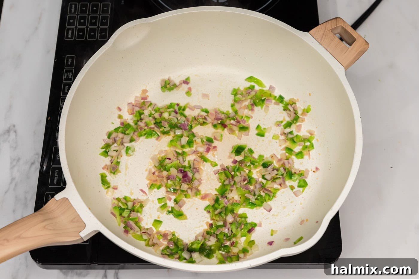 sauteed bell peppers, onion, and garlic in a skillet