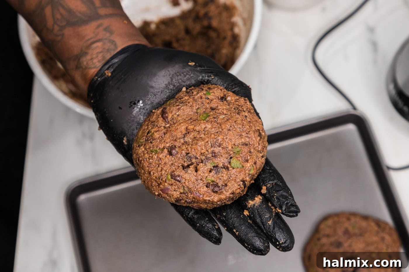 hand holding black bean burger patty