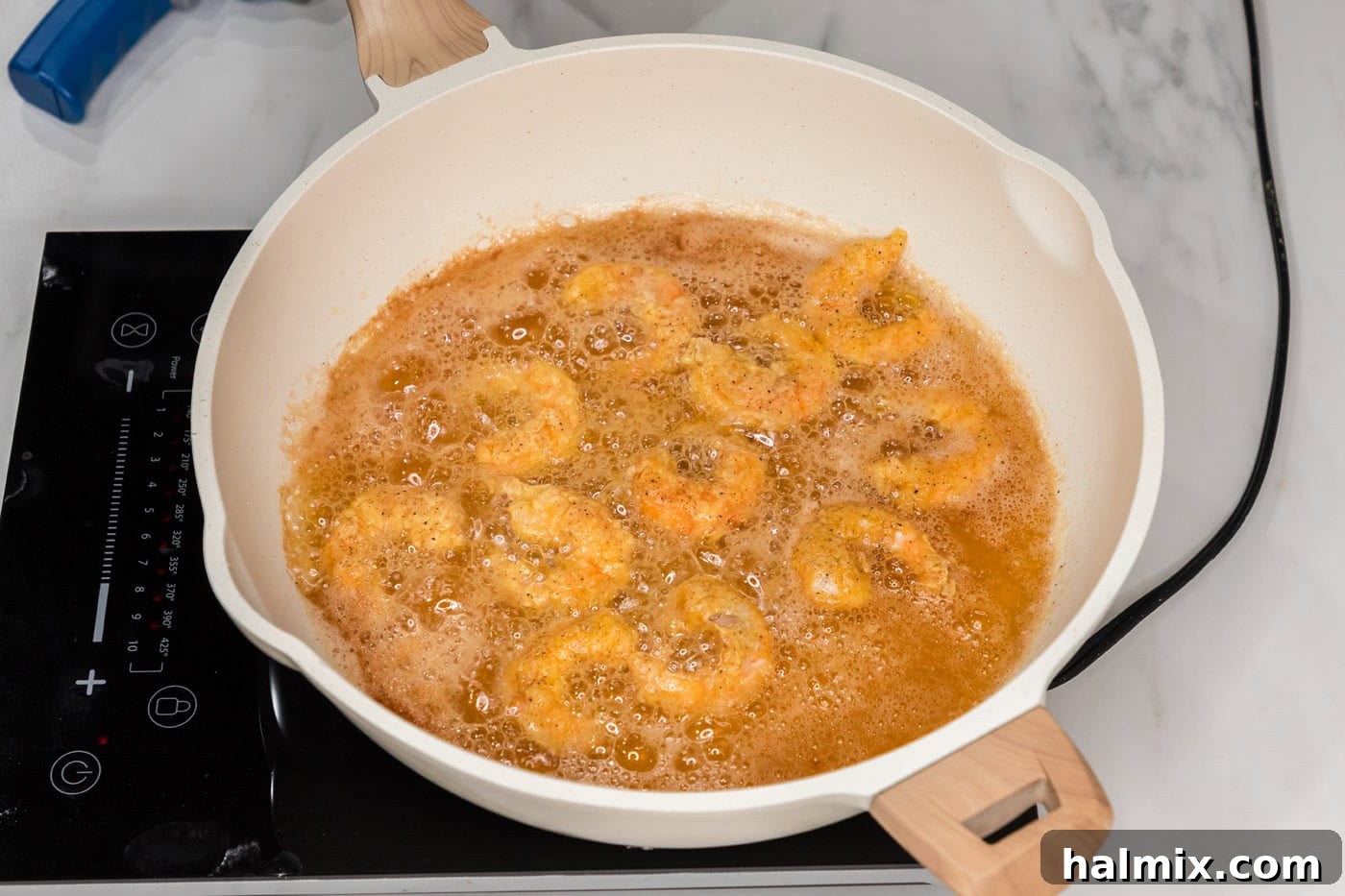 Thunder Shrimp 13 Perfectly fried shrimp in a skillet with oil, showing golden crispiness.
