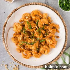 Plate of Boom Boom Shrimp topped with green onion and sesame seeds