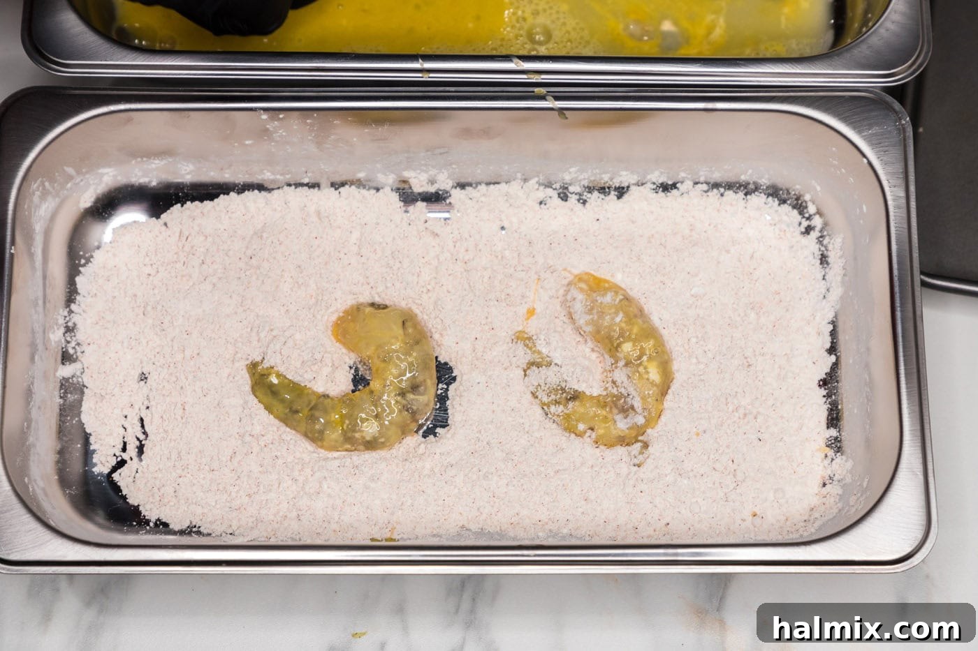 Thunder Shrimp 10 Dredging shrimp in the final seasoned flour and egg mixture.