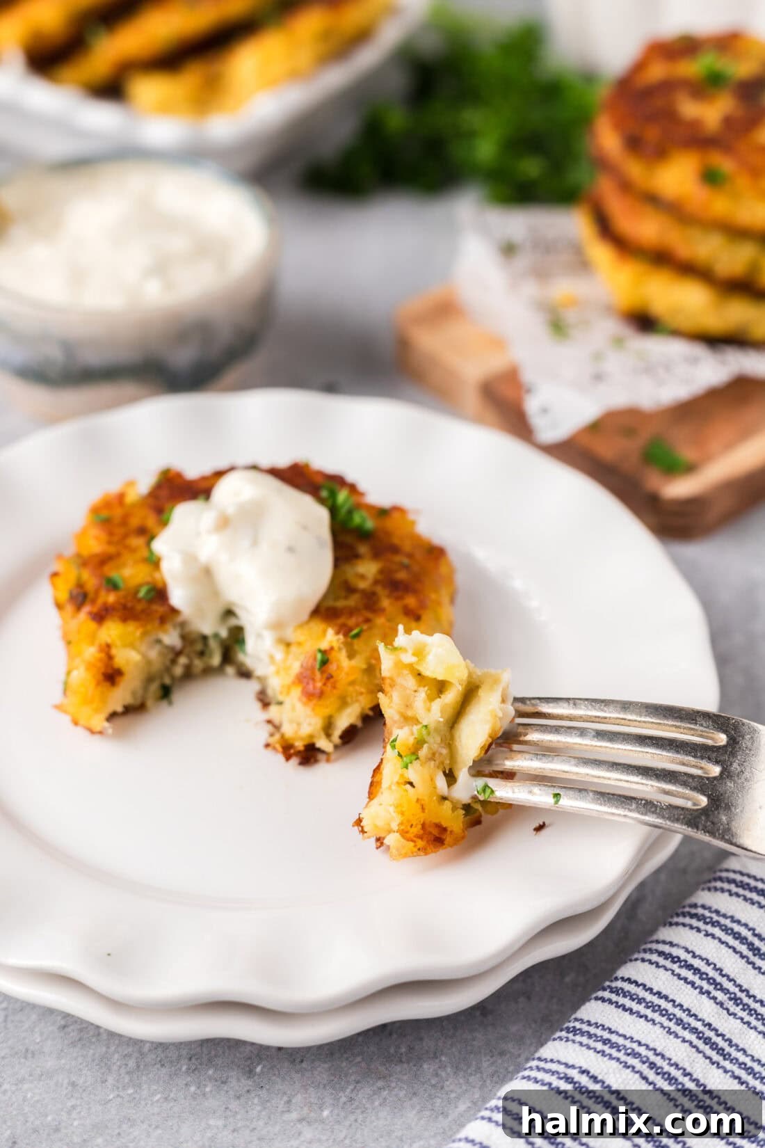 Golden Cod Fritters 6 Close-up of a Cod Fish Cake on a plate with a fork