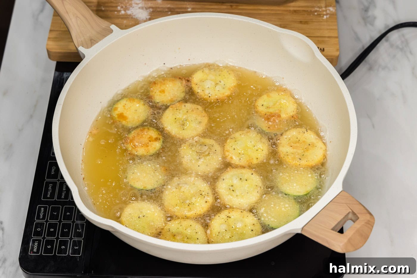 Golden Fried Squash 10 A skillet filled with hot oil, frying yellow squash and zucchini to a golden crisp.