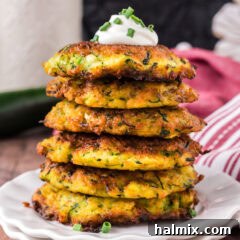 Close up photo of a stack of Zucchini Fritters on a plate, ready to be served