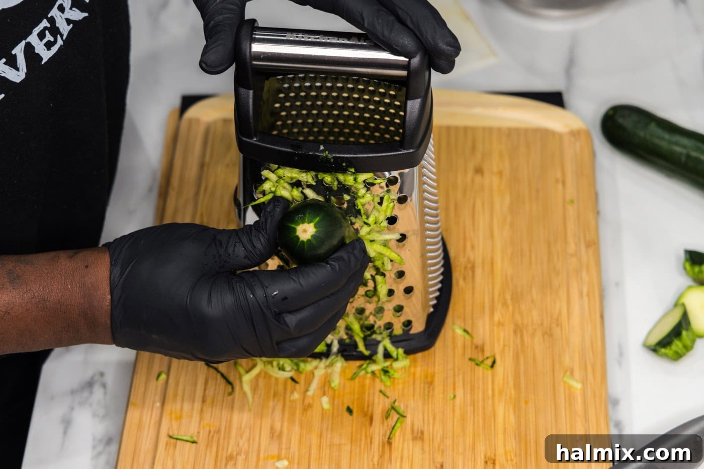 Golden Zucchini Delights 5 Chef shredding zucchini on a box grater