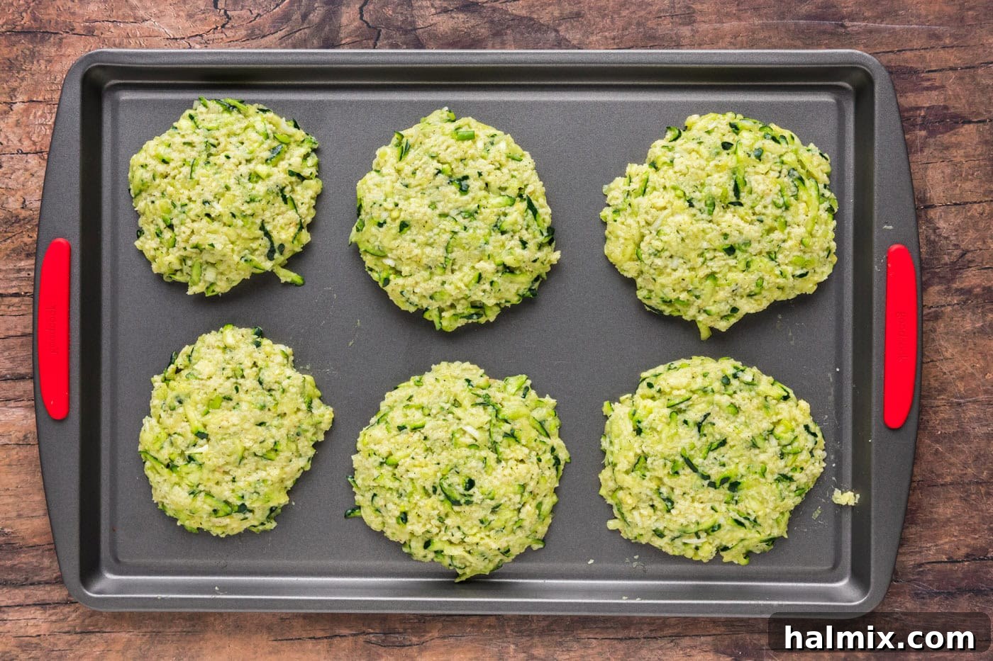 Golden Zucchini Delights 10 Six zucchini fritter patties arranged on a baking sheet before chilling