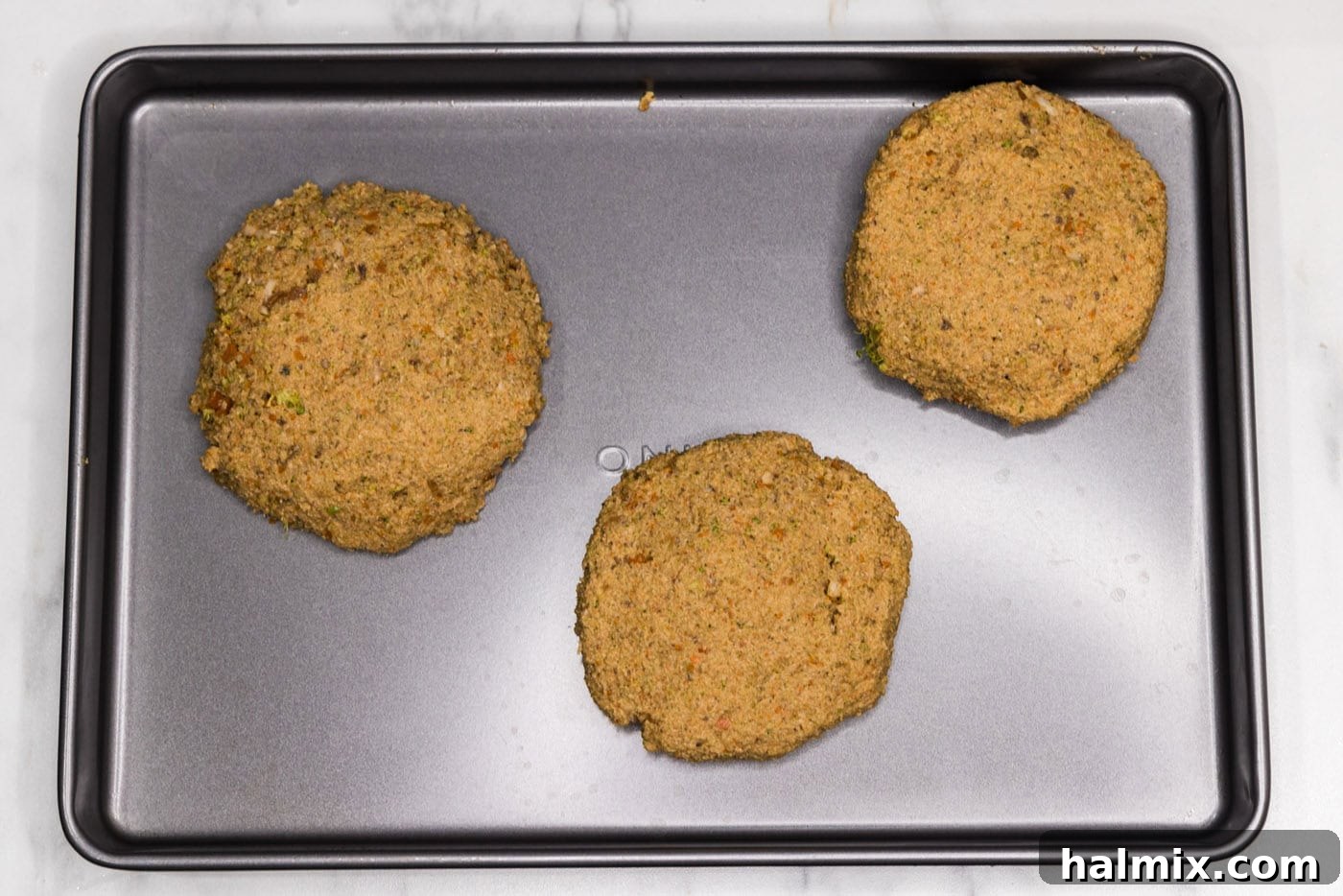 veggie burger patties on a baking sheet