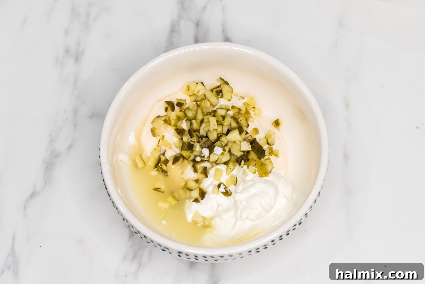 diced pickles, mayo, sour cream, and lemon juice in a bowl