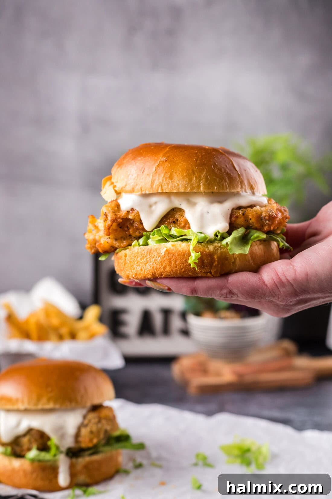 Hand holding up a Crispy Chicken Burger