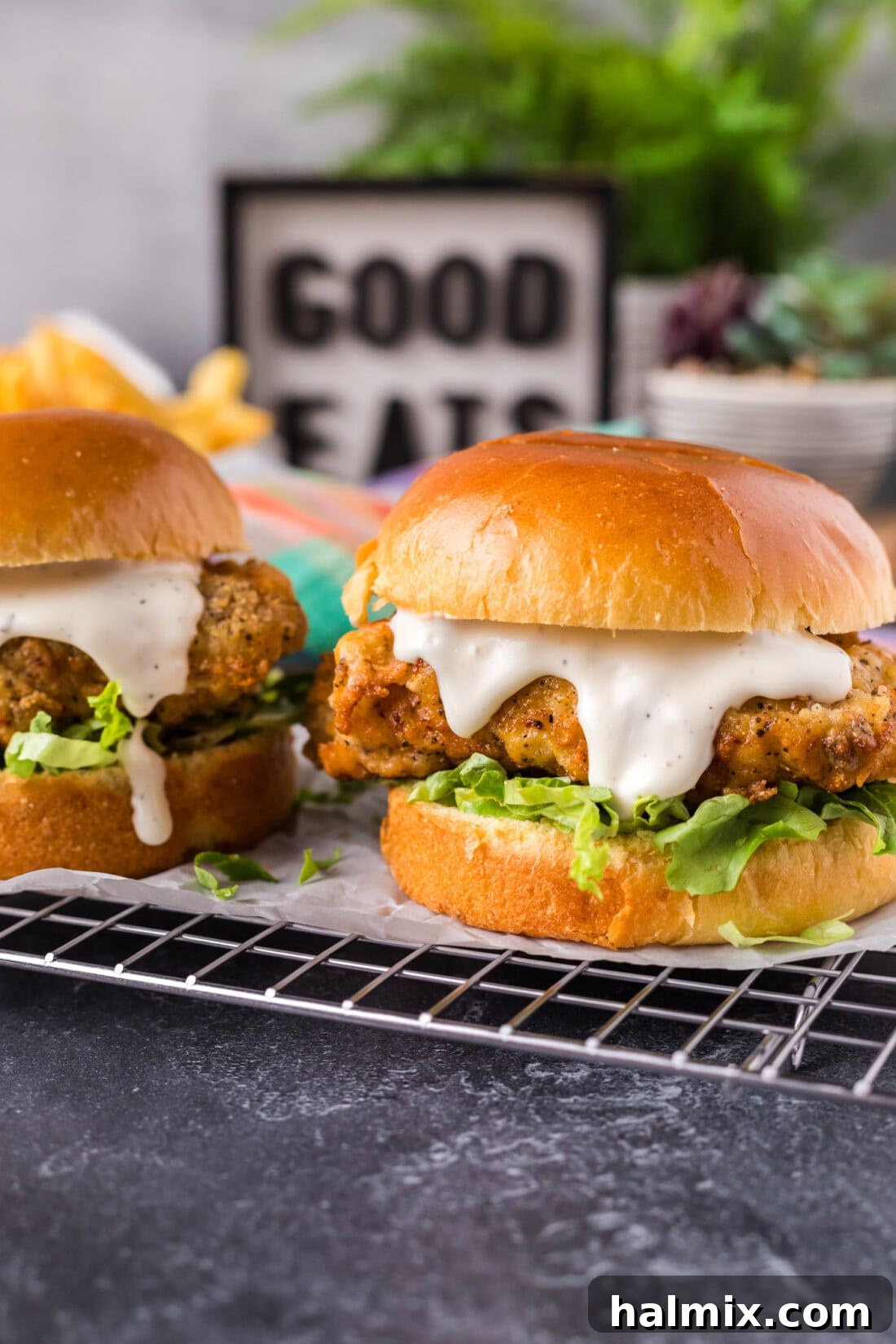 Two Crispy Chicken Burgers parchment lined wire rack