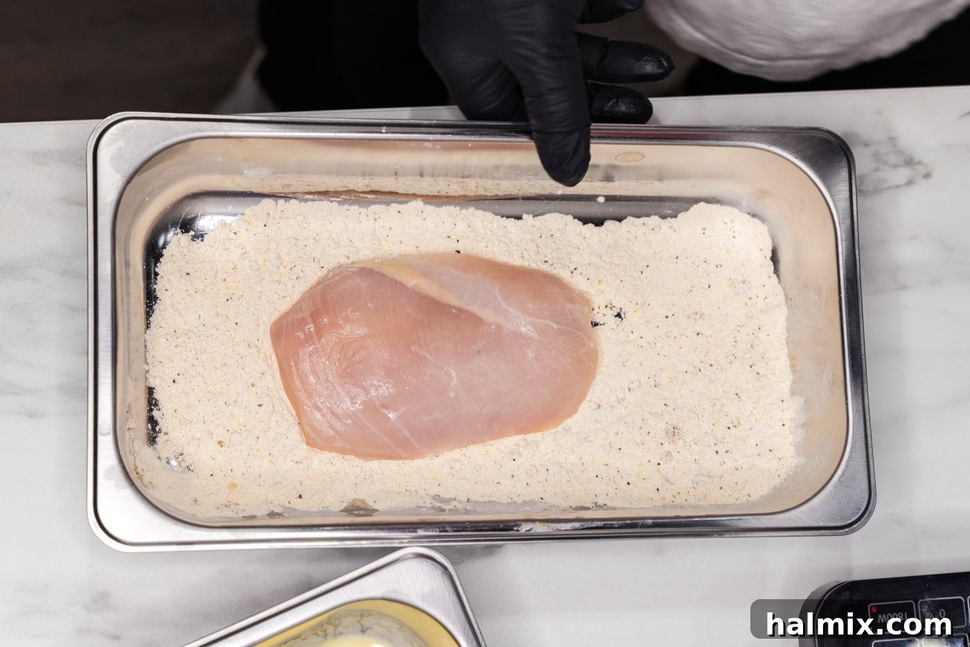chicken breast dipped in flour and seasonings