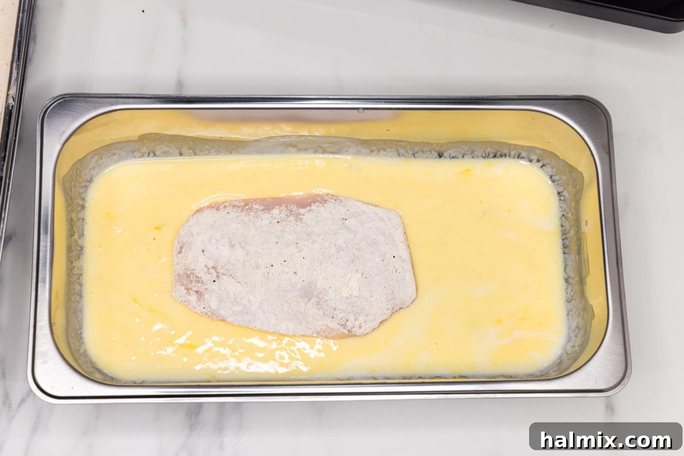 breaded chicken breast in buttermilk mixture