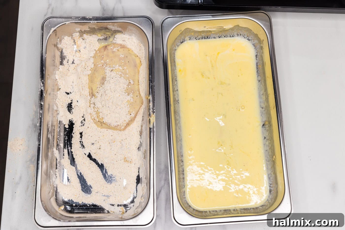 coating dredged chicken patty in flour