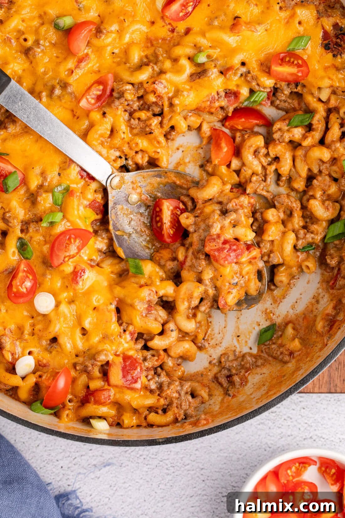 Loaded Taco Macaroni and Cheese 3 Close up photo of a spoon in a skillet of Taco Macaroni and Cheese
