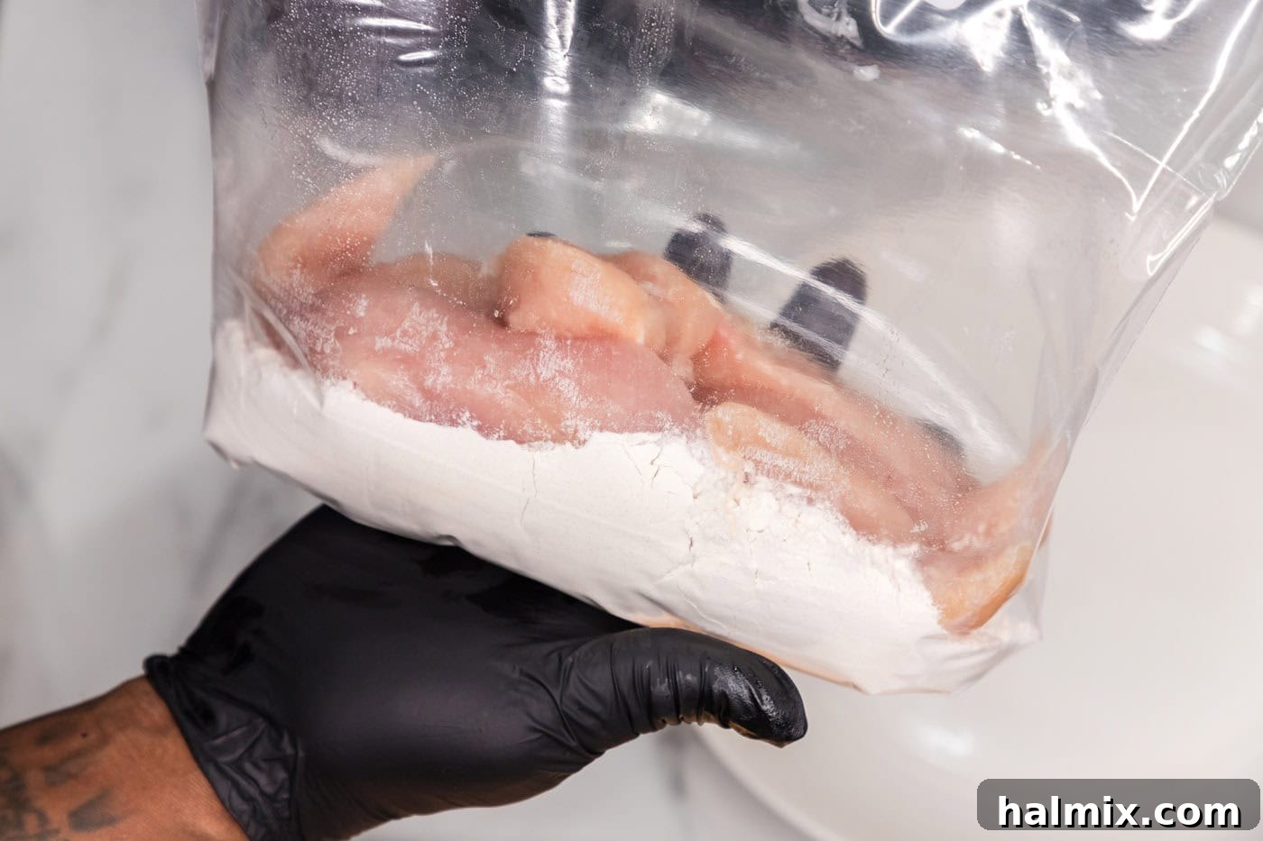 chicken tenderloins in a bag of flour