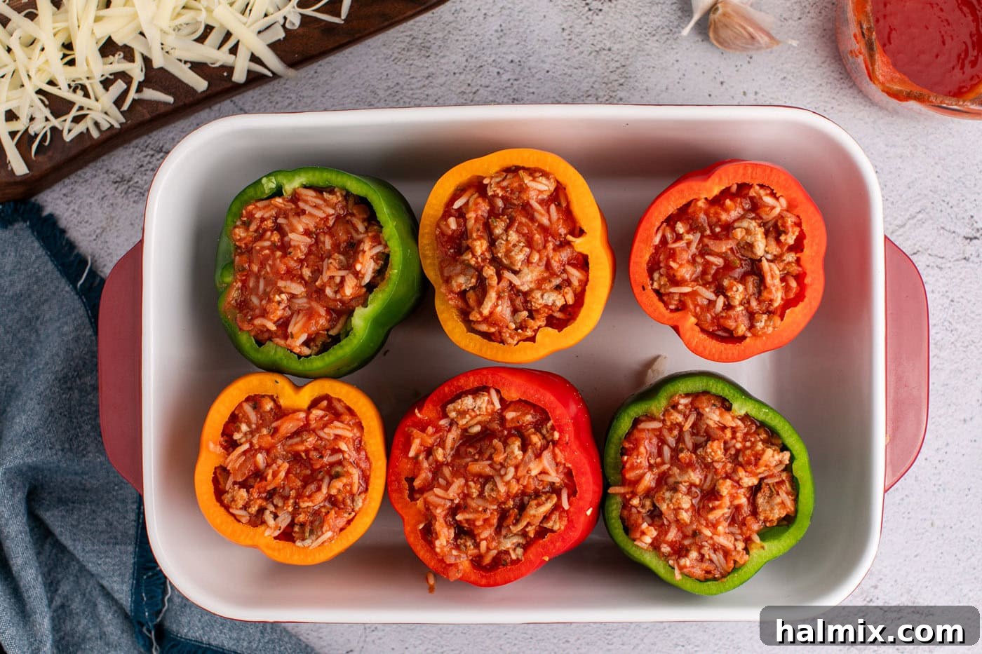 bell peppers with rice and turkey filling in a casserole dish