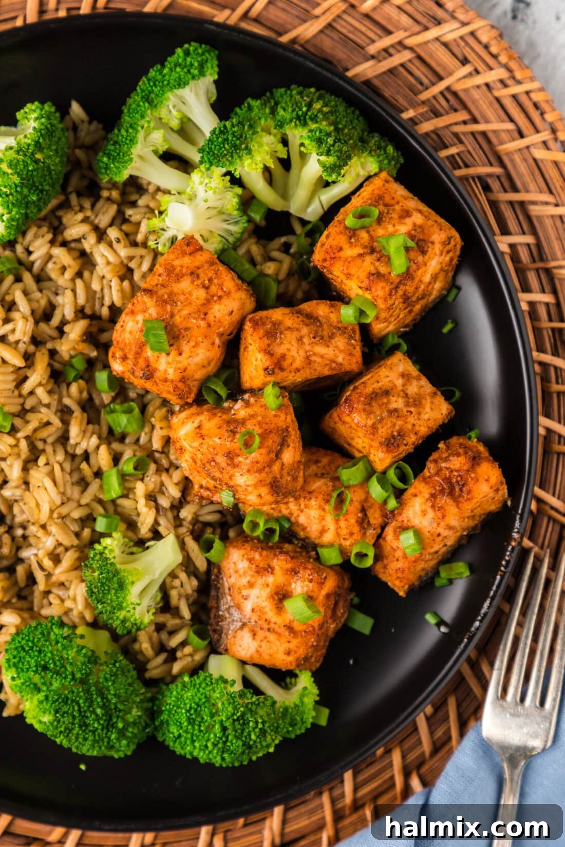 Golden Air Fryer Salmon Bites 2 Close up photo of Air Fryer Salmon Bites plated with broccoli and rice