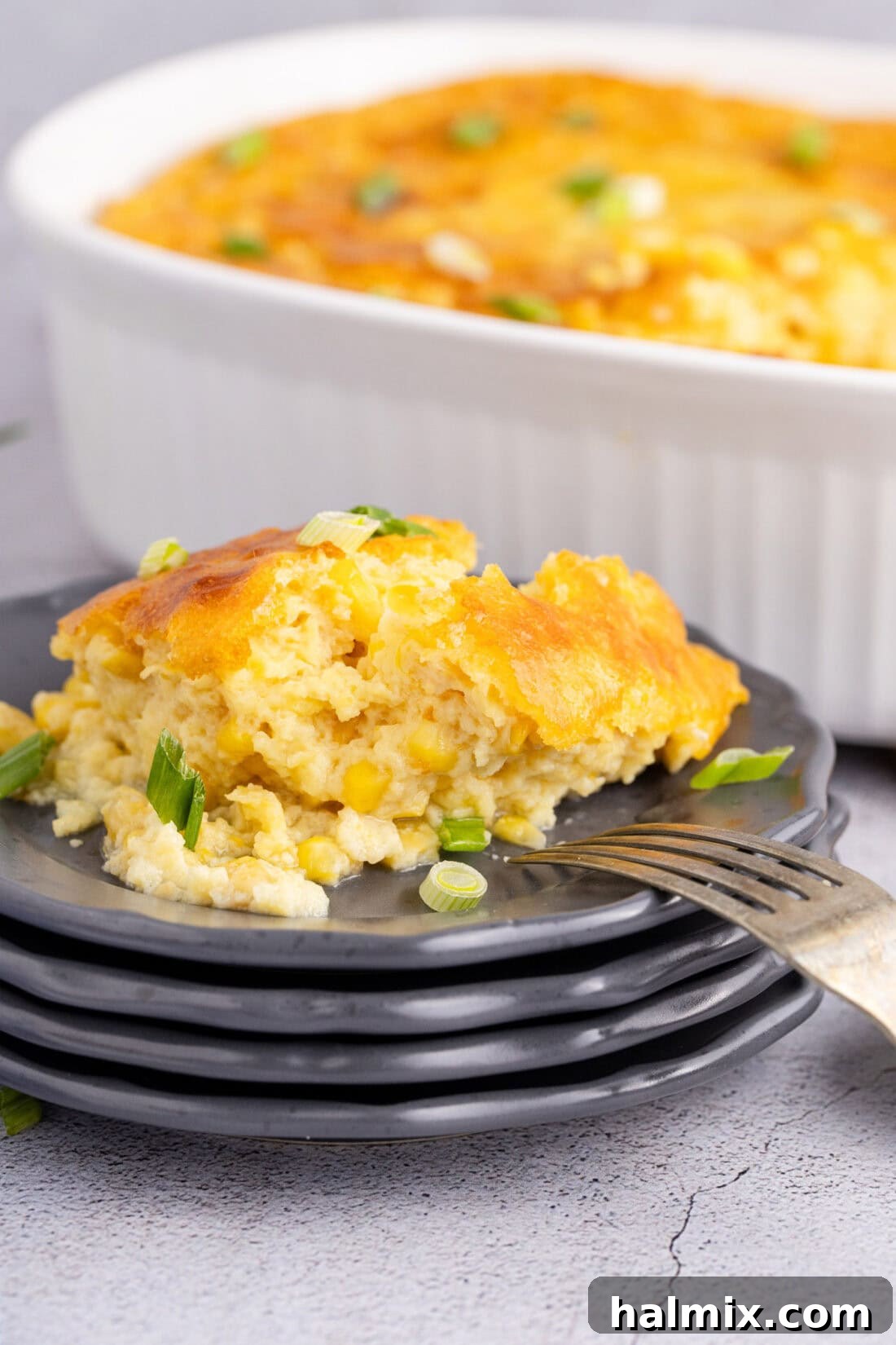 Corn Pudding on a plate with a fork
