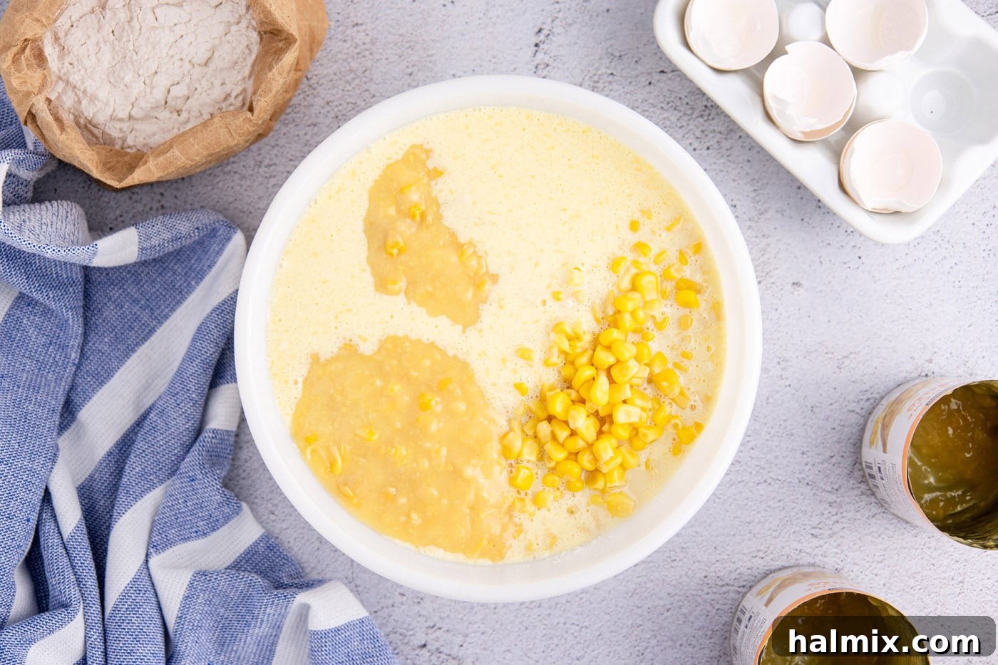 corn kernels and cream corn added to corn pudding batter