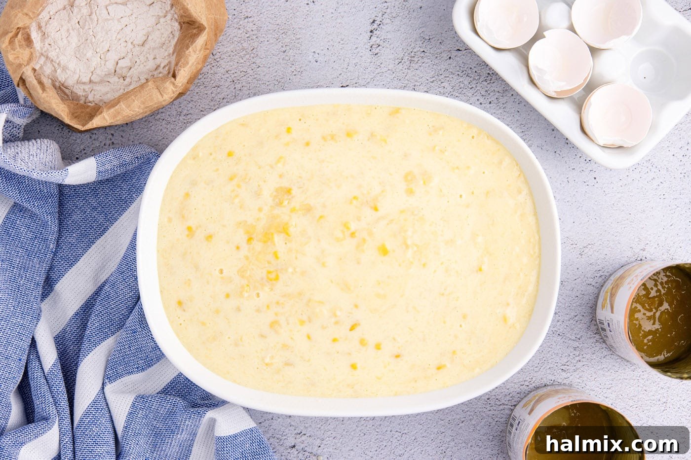 overhead shot of corn pudding in an oval baking dish