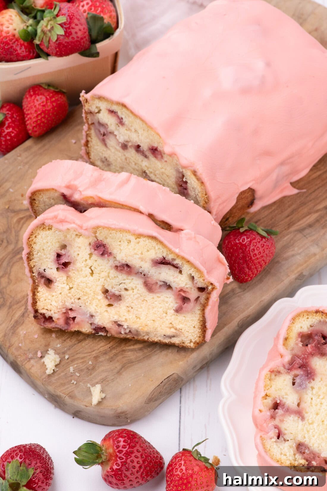 Fresh Strawberry Pound Cake 3 Strawberry Pound Cake on a wooden board with two slices cut