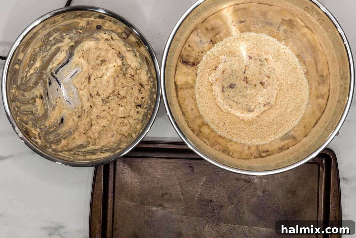 A shrimp burger patty being pressed into a bowl of panko breadcrumbs to create a crispy coating.