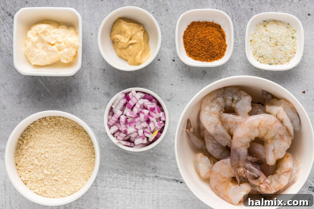A vibrant display of fresh ingredients for shrimp burgers, including raw shrimp, panko, red onion, and seasonings.