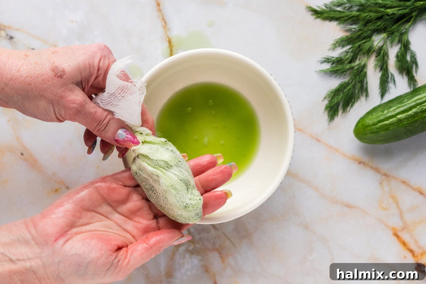 Close-up of shredded cucumber after being thoroughly squeezed in a cheesecloth, showing its dry, fluffy texture, essential for preventing a watery Tzatziki Sauce.